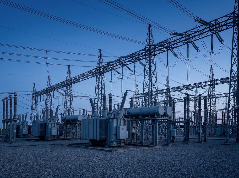 High-voltage substation with SF6 gas-insulated switchgear and circuit breakers at dusk